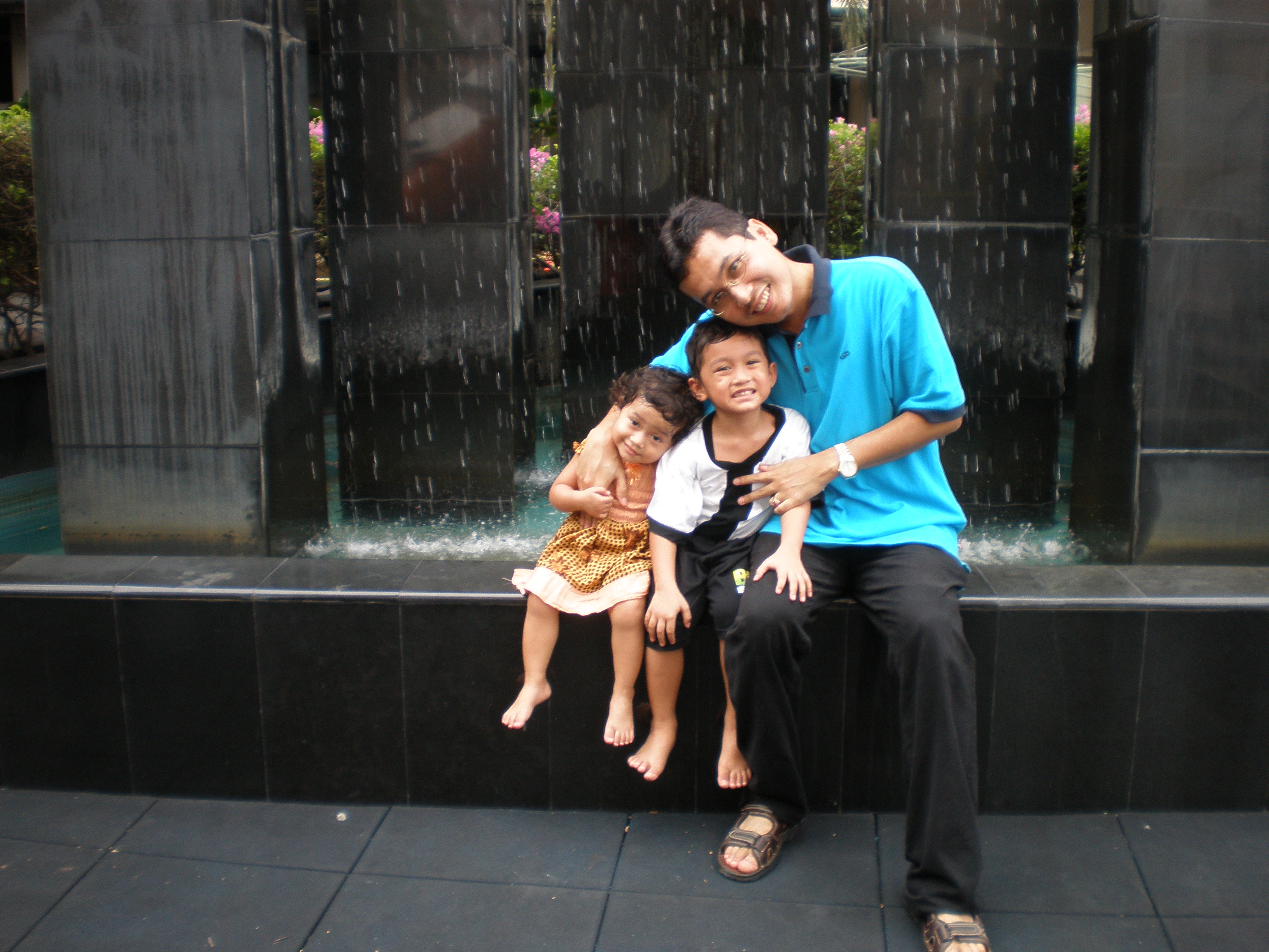 The reason Shahril had to hold them like that is because 1. They were afraid of the fountain kat belakang tu. :) 2. They wanted to run around some more.